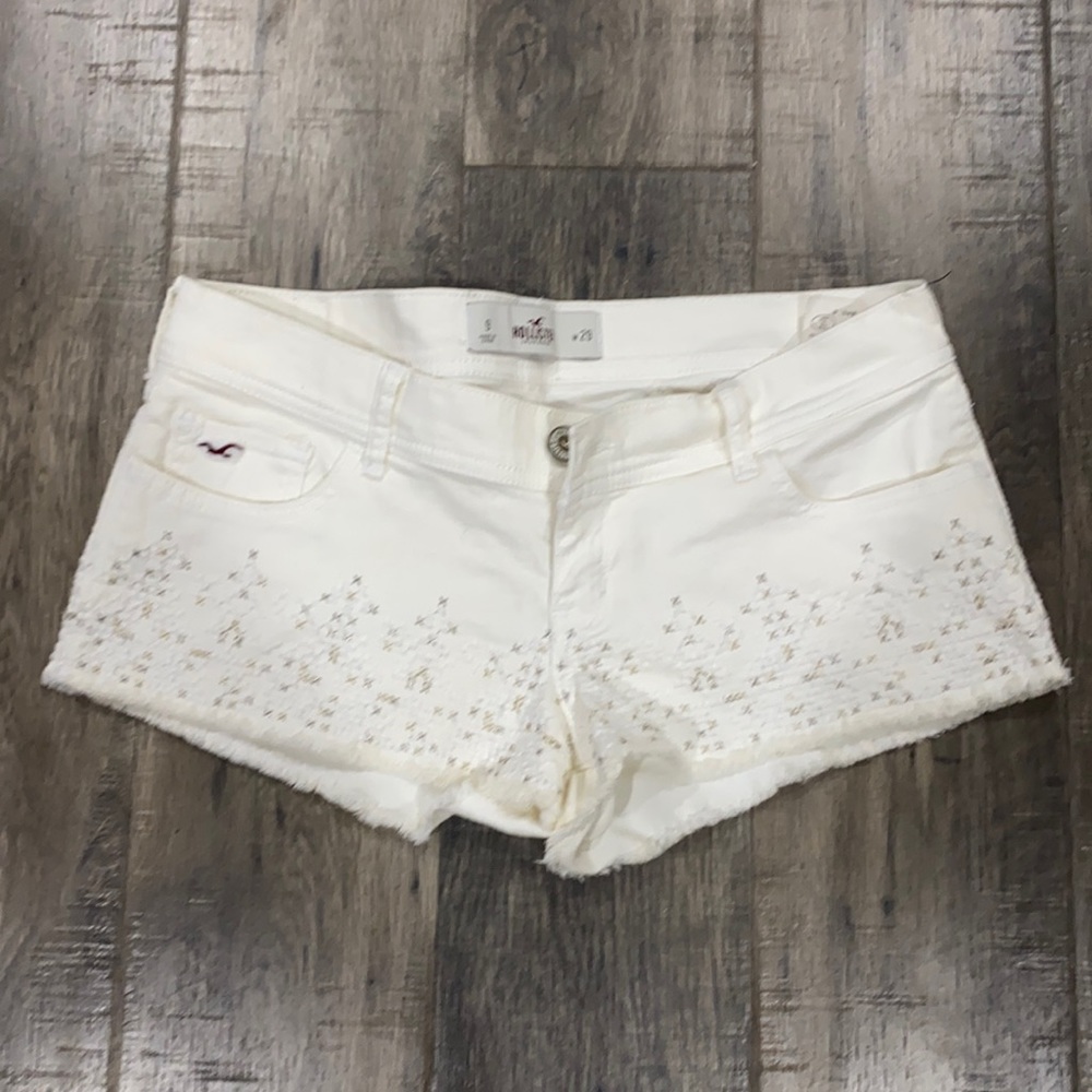 White Hollister shorts with gold stitched decor